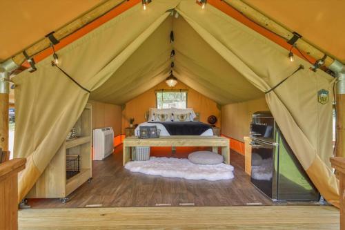 a bedroom in a tent with a bed in it at In A Meading - Safari Tent - BeeWeaver Honey Farm in Navasota