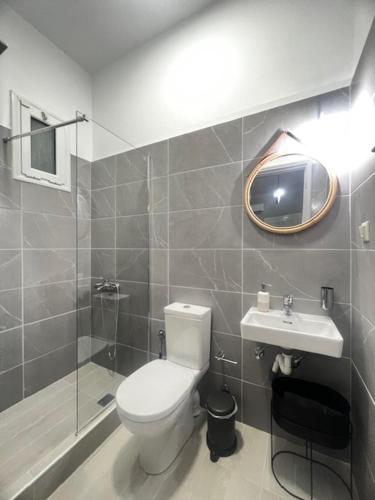 a bathroom with a toilet and a sink at LA COSTA DI SAN GIORGIO in Agios Georgios