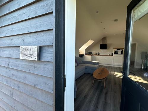a living room and kitchen with a sliding barn door at The Old Piggery, Cart Lodge in Newbourne in Newbourn