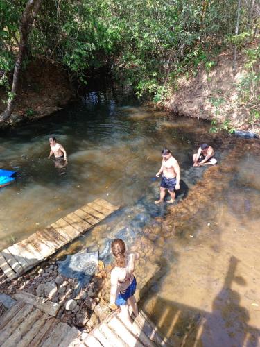 a group of people swimming in a river at Camping e Balneário Rio dos Bugres in Porcas