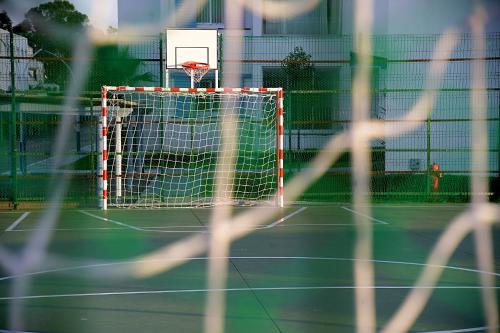 a net on a tennis court with a basketball hoop at InHome Apartment in Cabo Negro