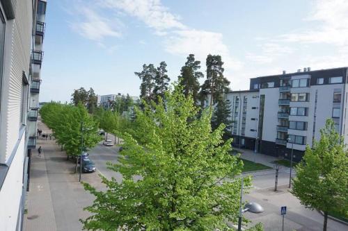 a view of a street with trees and buildings at Lovely apartment near the Beach in Helsinki
