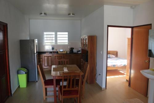 a kitchen with a table and a dining room at Schitterend gelegen tweekamerwoning in Paramaribo
