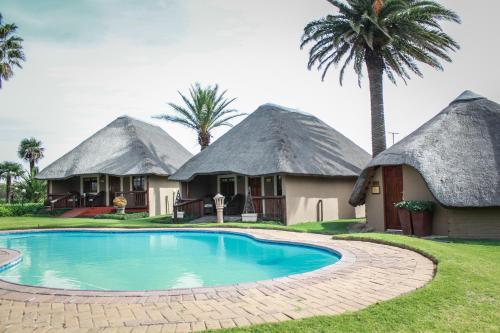 a group of hacienda style homes with a pool at Siesta Guesthouse & Wedding Venue - Frankfort in Frankfort