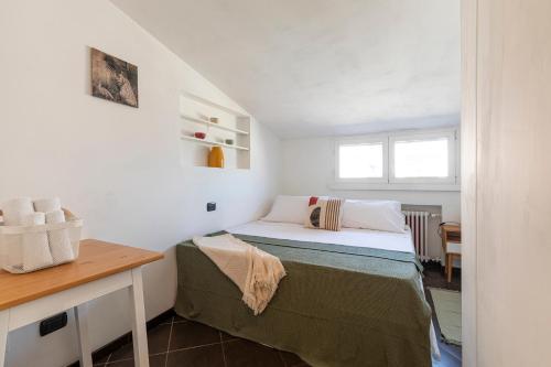 a small bedroom with a bed and a desk at MiCo Apartment in Fiera Milano City in Milan