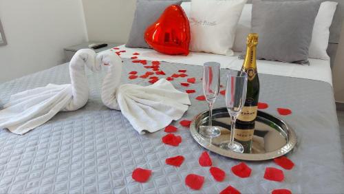 a bed with two champagne bottles and hearts on it at Loft Pozzillo in Monreale
