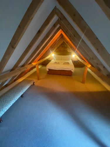 a attic room with a bed in the attic at Seafret Barn 4 plus 2 in Roughton