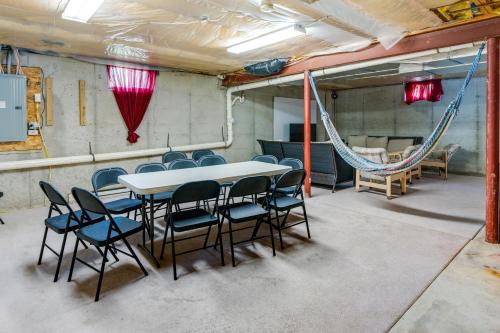 a room with a table and chairs and a hammock at Centrally Located Family Home with Pool in Harleysville