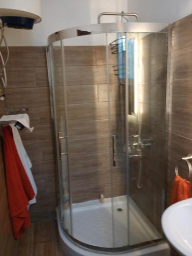 a shower with a glass door in a bathroom at Himma's Apartments in Adonkia