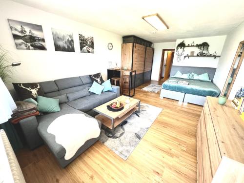 a living room with a couch and a table at Moderne, 1-Zimmer Ferienwohnung mit Bergblick in Oy-Mittelberg