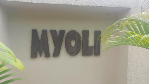 a sign that says wow hanging on a wall at Myoli Wellness & Happiness BnB in Playa del Carmen