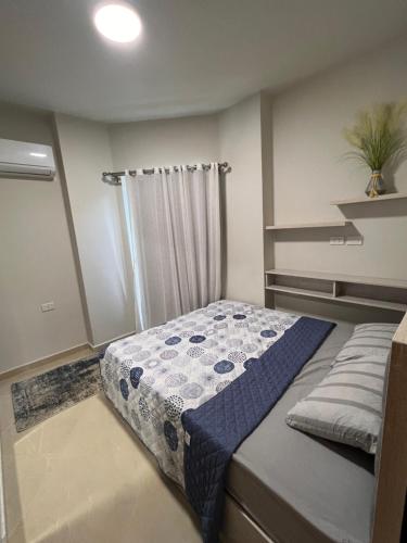 a small bedroom with a bed with a shower at Princess Resort (Rayan) in Hurghada
