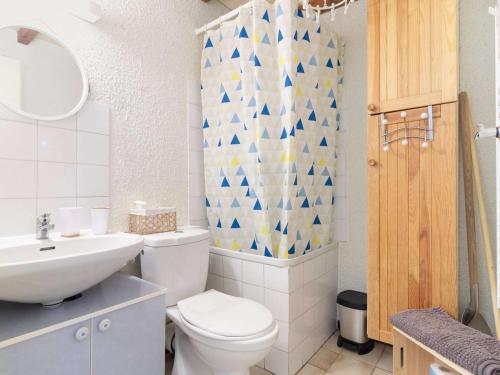 a bathroom with a white toilet and a sink at Appartement Cauterets, 2 pièces, 6 personnes - FR-1-401-152 in Cauterets