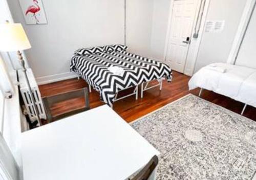 a living room with two beds and a couch at Legacy - Spring Garden University City in Philadelphia