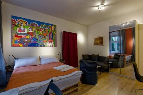 a bedroom with a large bed and a living room at Wohnung 3 neben Warschauer Platz und Spree in Berlin