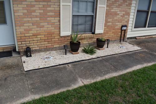 a house with potted plants in front of a house at Comforts of Home in Gautier