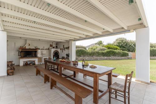 a kitchen and dining room with a wooden table and chairs at Aurora in Stelida