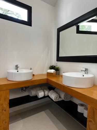 a bathroom with two sinks and a large mirror at The Loft Junction in Funchal