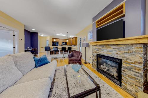a living room with a couch and a fireplace at Brydcliffe Butte in Asheville