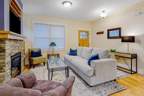 a living room with a couch and a fireplace at Brydcliffe Butte in Asheville