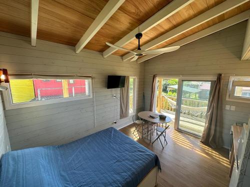 a bedroom with a bed and a ceiling fan at Amphibias in Punta Del Diablo