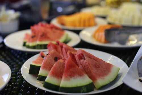 a group of plates of watermelon slices on a table at Stop Inn Antonio Carlos in Belo Horizonte