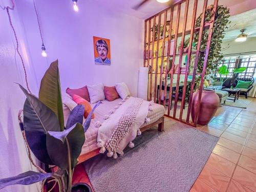 a room with a bed and a plant in it at Casa Paloma - Zona Romantica in Puerto Vallarta