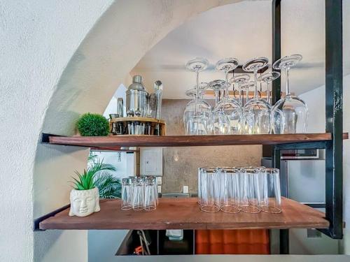 a bunch of glasses sitting on shelves in a room at Casa Paloma - Zona Romantica in Puerto Vallarta