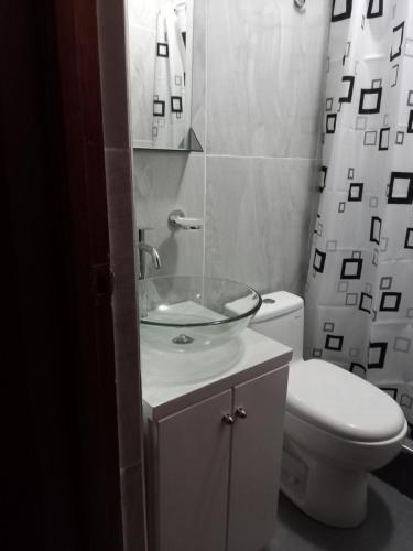 a bathroom with a sink and a toilet at RESIDENCIAL LORENA in Tacna