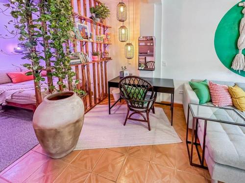 a living room with a vase and a table and a couch at Casa Paloma - Zona Romantica in Puerto Vallarta