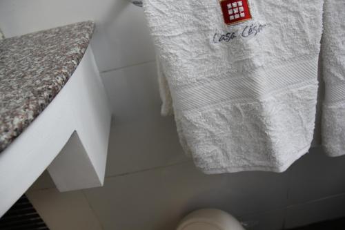 a towel is hanging over a toilet in a bathroom at HOTEL Casa cesar in Tumbes