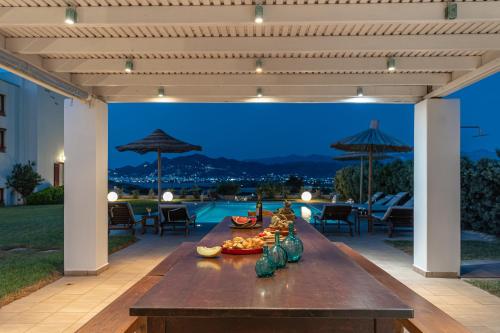 a patio with a table and a view of a pool at Aurora in Stelida