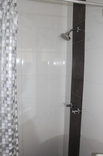 a bathroom with a shower with a glass door at HOTEL Casa cesar in Tumbes