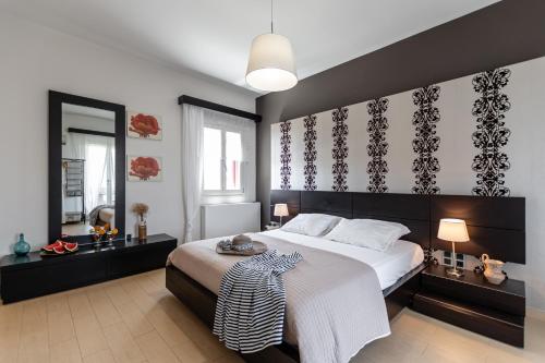a bedroom with a large bed and two windows at Aurora in Stelida