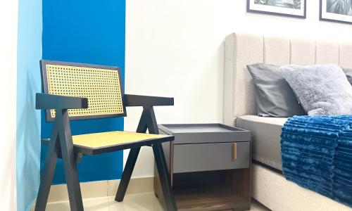 a bedroom with a chair next to a bed at Alanis Suite With Netflix @ KLIA Sepang in Sepang