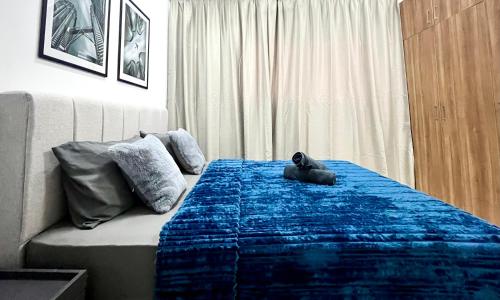 a dog laying on a bed in a bedroom at Alanis Suite With Netflix @ KLIA Sepang in Sepang