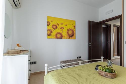 a bedroom with a bed and a painting on the wall at Aurora in Stelida