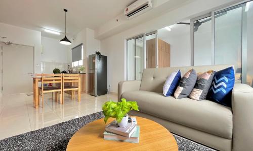 a living room with a couch and a table at Alanis Suite With Netflix @ KLIA Sepang in Sepang