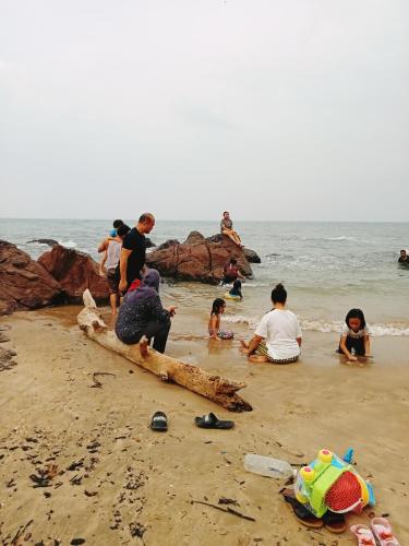 a group of people playing on the beach at The Dorm in Kampong Pandan