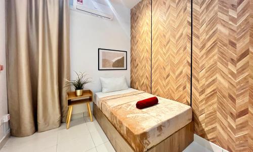 a small room with a bed with a red pillow on it at Alanis Suite With Netflix @ KLIA Sepang in Sepang