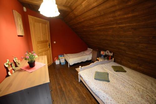 a attic room with two beds in a room at Resetówka - w dzień wyjazdu zostań do wieczora in Brenna