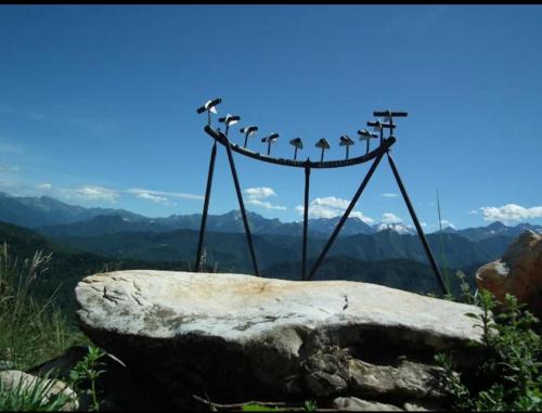 a weather vane on the top of a mountain at STARE BENE B&B in Bernezzo