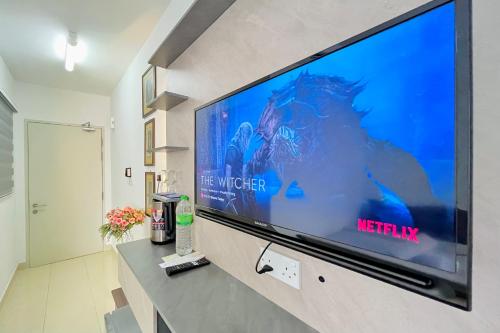 a large flat screen tv sitting on a wall at Alanis Suite With Netflix @ KLIA Sepang in Sepang