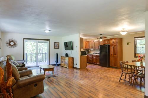 a kitchen and living room with a couch and a table at Riverfront Covington Cabin with Deck and Fire Pit! in Piqua