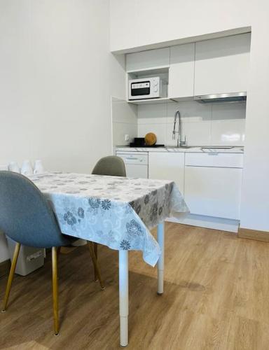 a kitchen with a table with a table cloth on it at Studio with sea view in Cascais in Cascais