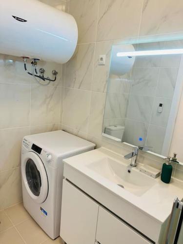 a bathroom with a washing machine and a sink at Studio with sea view in Cascais in Cascais