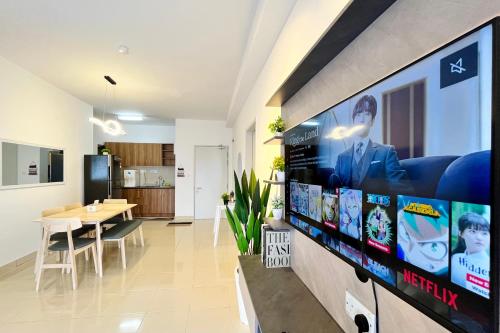 a living room with a large tv on a wall at Alanis Suite With Netflix @ KLIA Sepang in Sepang