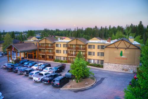an aerial view of a hotel with cars parked in a parking lot at Whitefish Riverfront Hotel in Whitefish