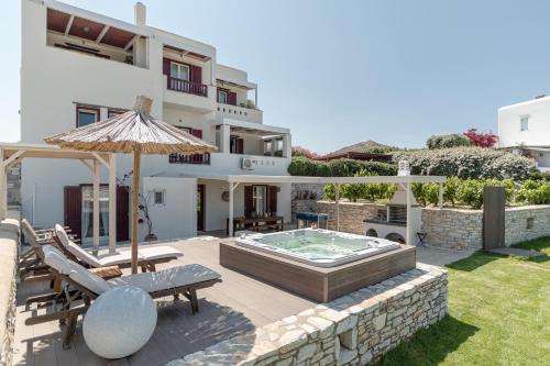 a villa with a swimming pool and a house at Aurora in Stelida