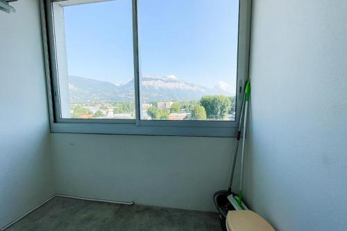 a room with a window with a view of a mountain at #FV The art of living Clim Rénové in Saint-Martin-dʼHères
